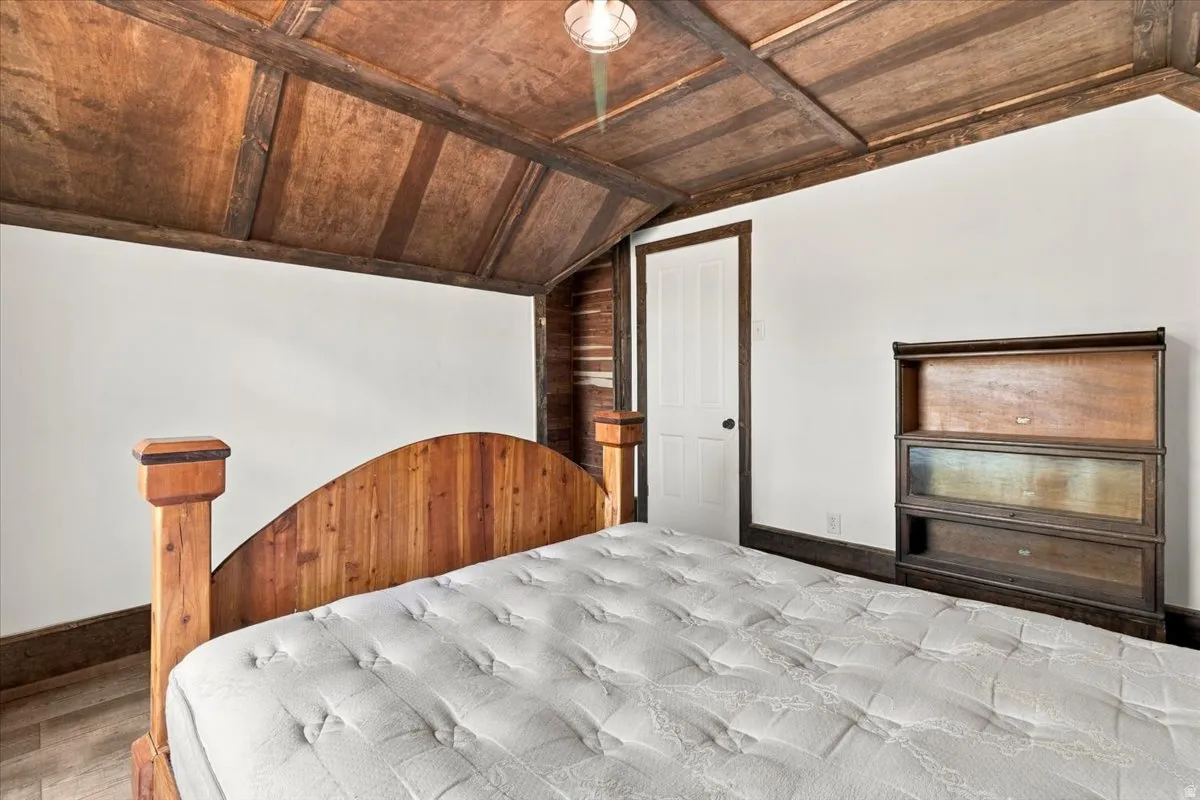 Wood-paneled sloped ceiling with exposed beams