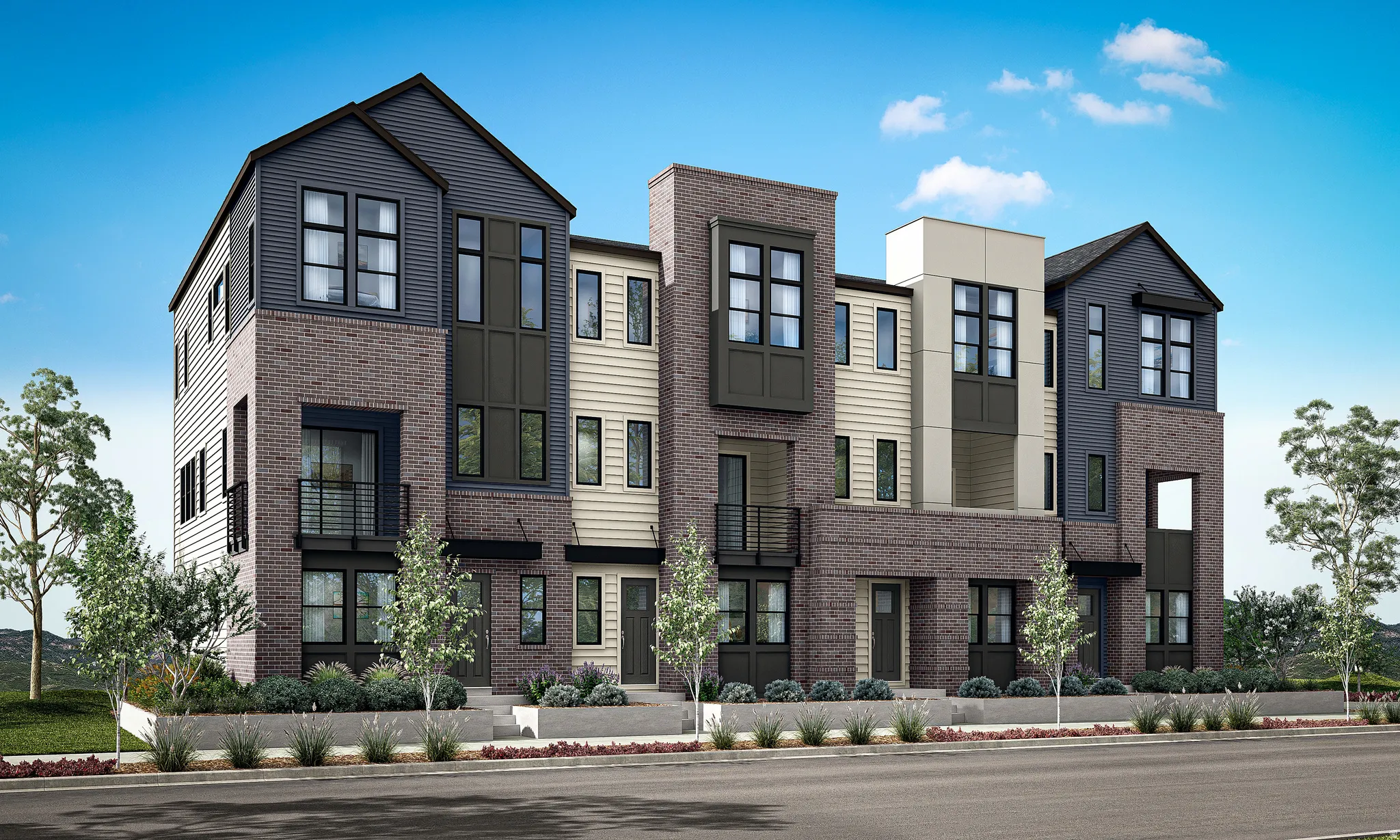 Multi-level townhome-style residences featuring brick and siding exteriors, modern window designs, street-level entrances, and integrated landscaping