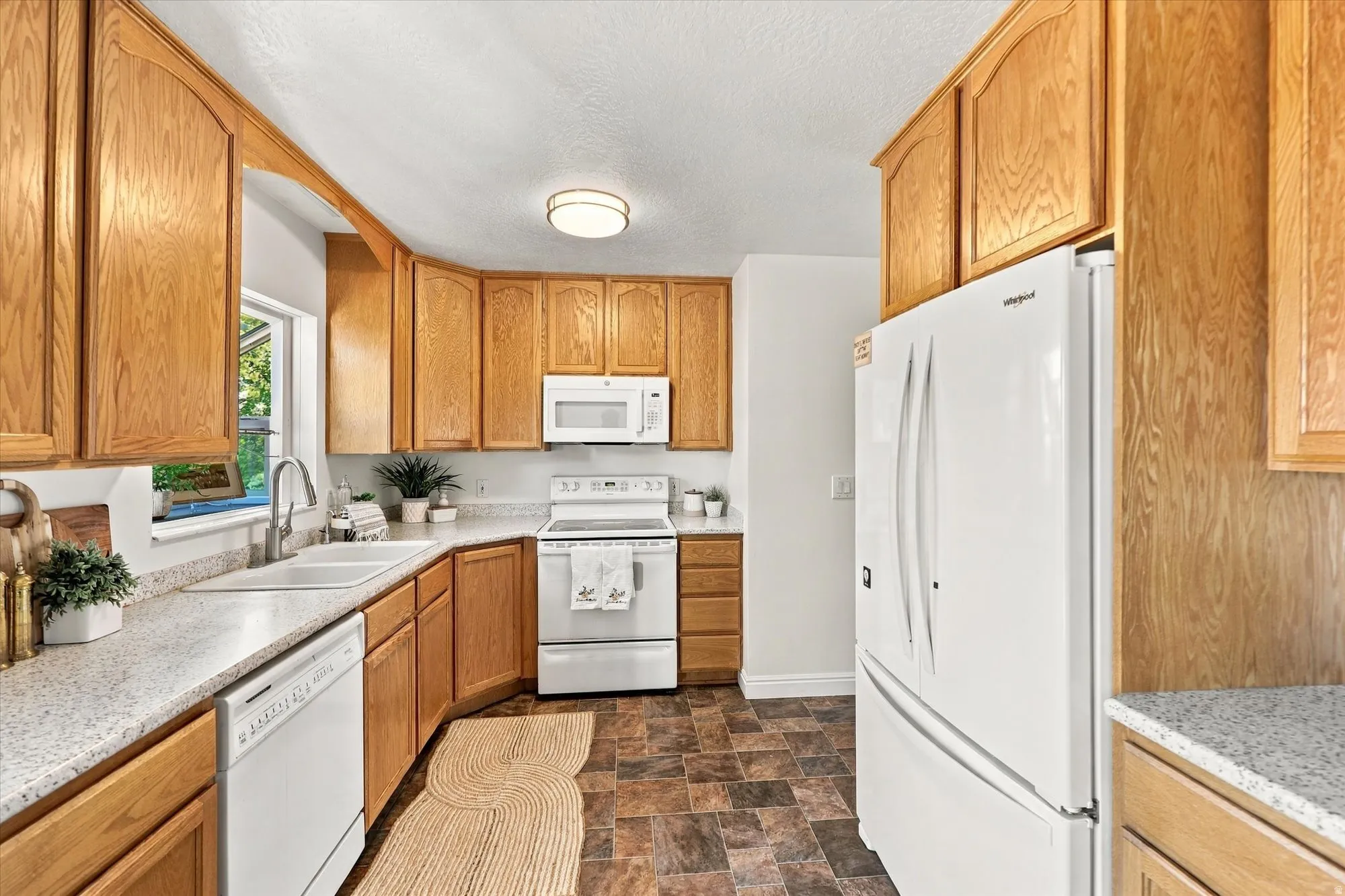 Wood-finish cabinetry paired with light-toned countertops