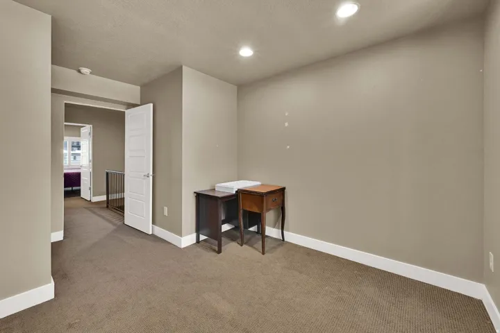 Bedroom #2 with neutral paint and a charming window detail.
