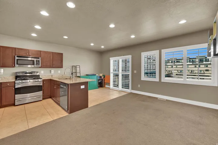 Open Kitchen, dining and living room with access to balcony.