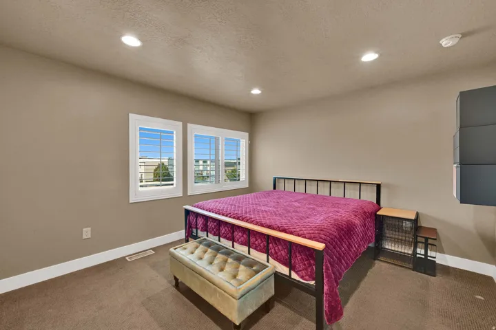 Neutral wall paint, recessed lighting, and carpeted flooring