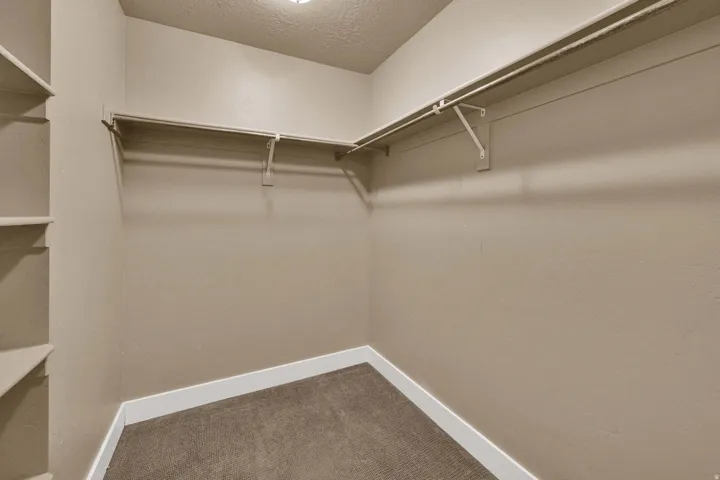 Built-in shelving, hanging rods, and neutral-toned walls