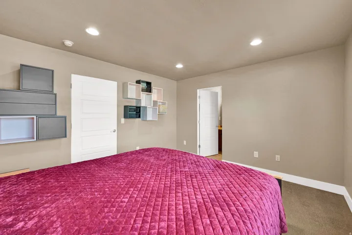 Neutral wall paint, recessed lighting, and carpeted flooring