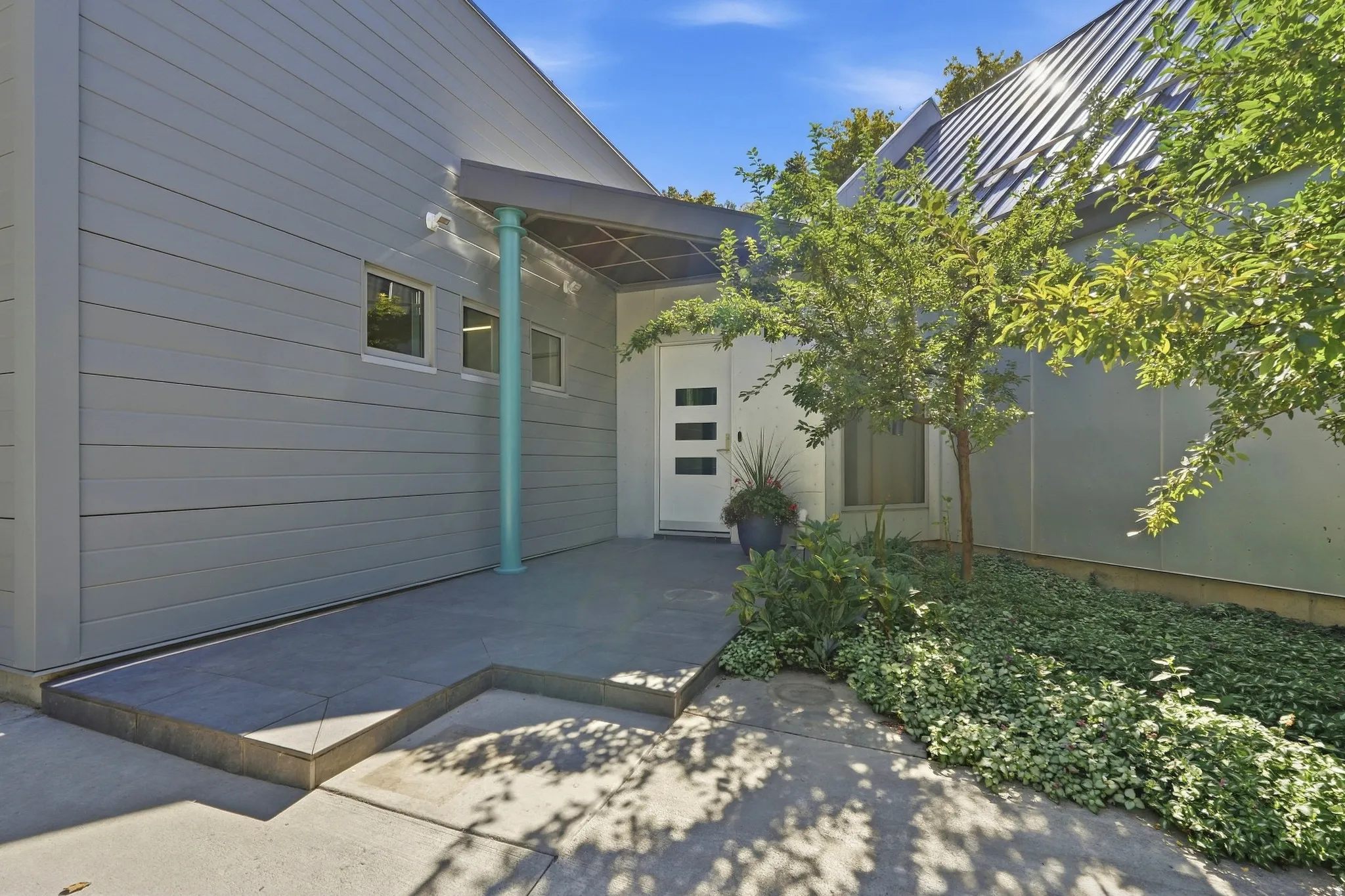 Modern exterior with horizontal siding and a metal roof