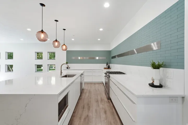 Gourmet kitchen with an expansive island, integrated sink, stainless steel appliances, and a gas cooktop