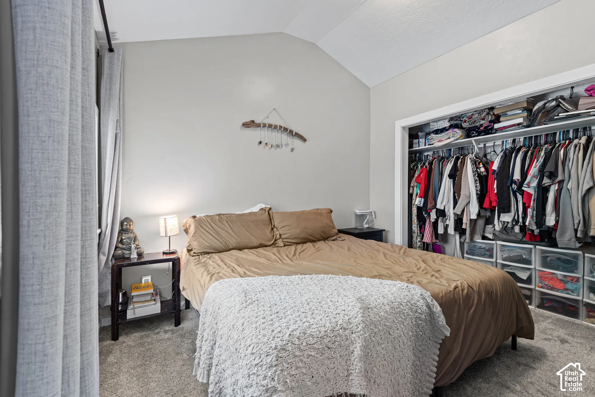 Master bedroom with vaulted ceiling and a large closet