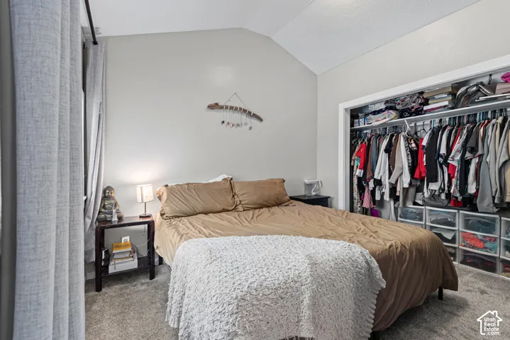 Master bedroom with vaulted ceiling and a large closet