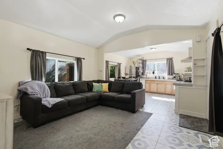 Vaulted ceilings, open floor plan, lots of light, gas range, and decorative tile flooring