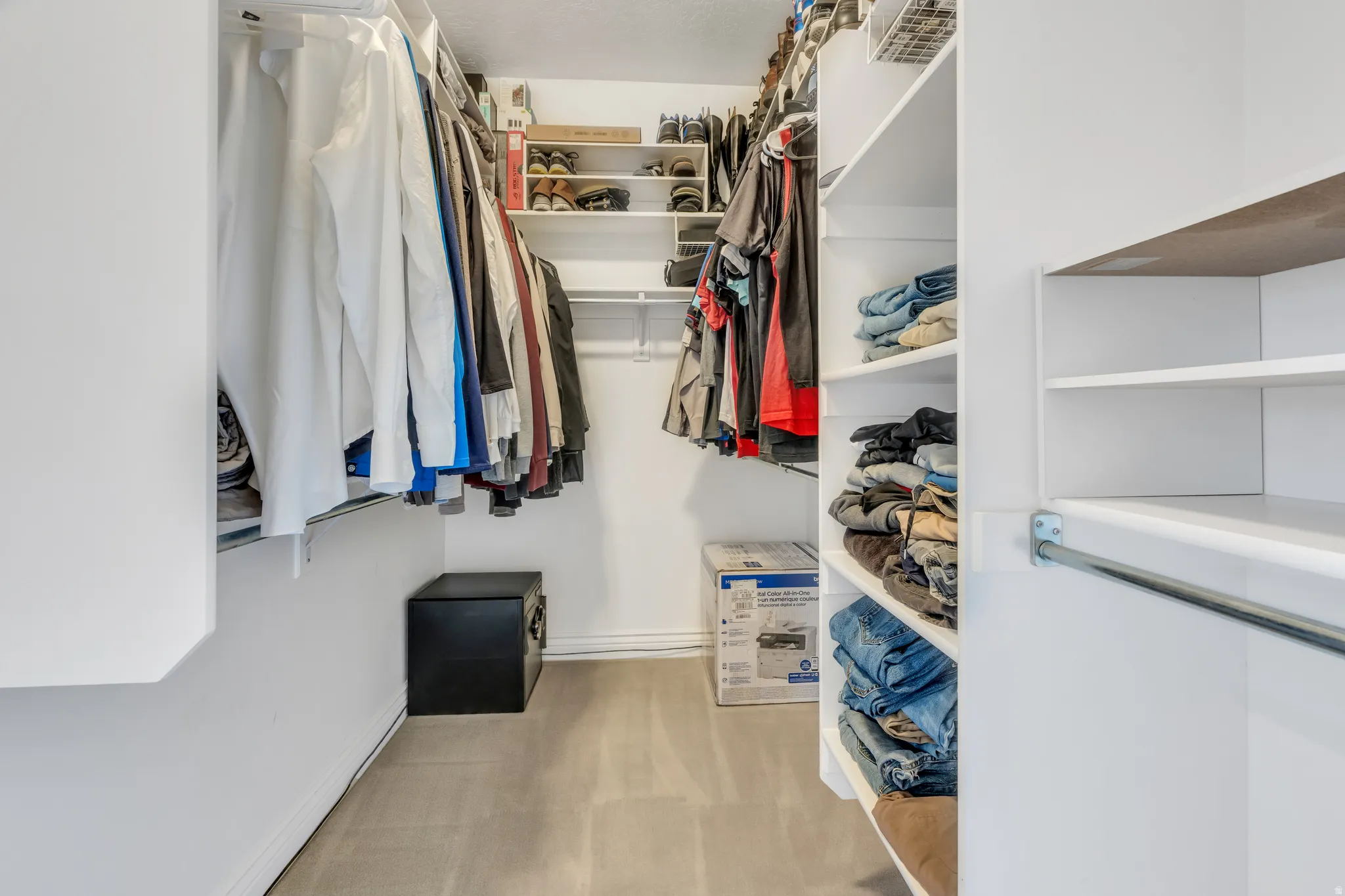 Built-in closet shelving and multiple hanging rods provide organizational options