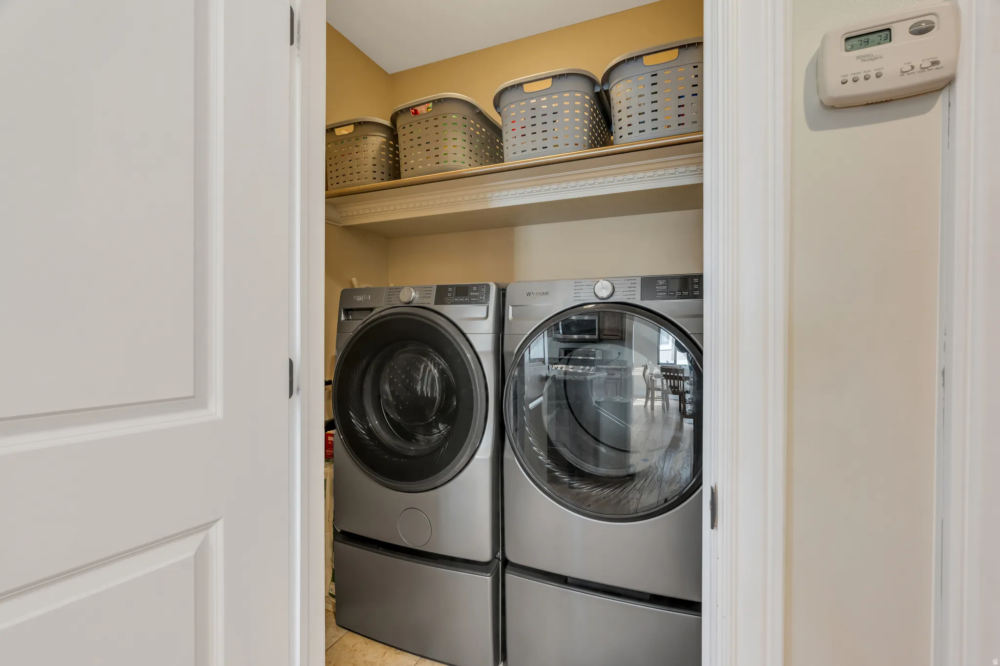 Integrated laundry appliances with storage shelf