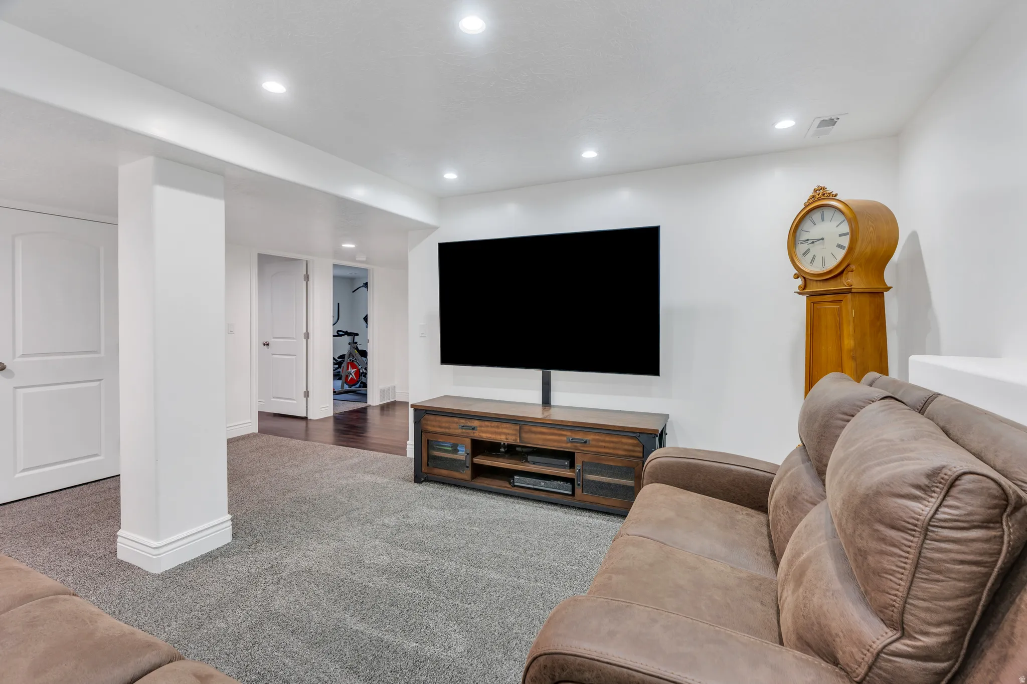Recessed lighting, white walls, and a grey carpeted floor