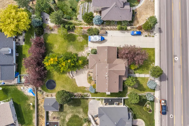 Expansive lot featuring mature trees, manicured lawns, and a private driveway