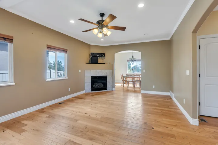 Wood-finish flooring, recessed lighting, and a ceiling fan