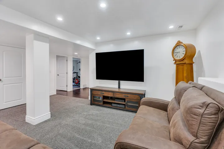 Recessed lighting, white walls, and a grey carpeted floor