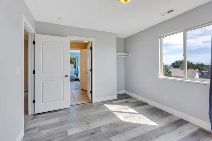 Light gray wall finishes with wood-finish flooring