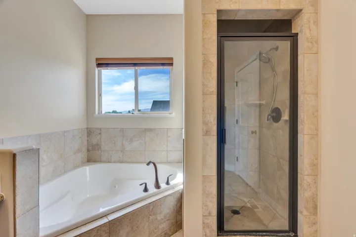 White soaking tub with oil-rubbed bronze fixtures