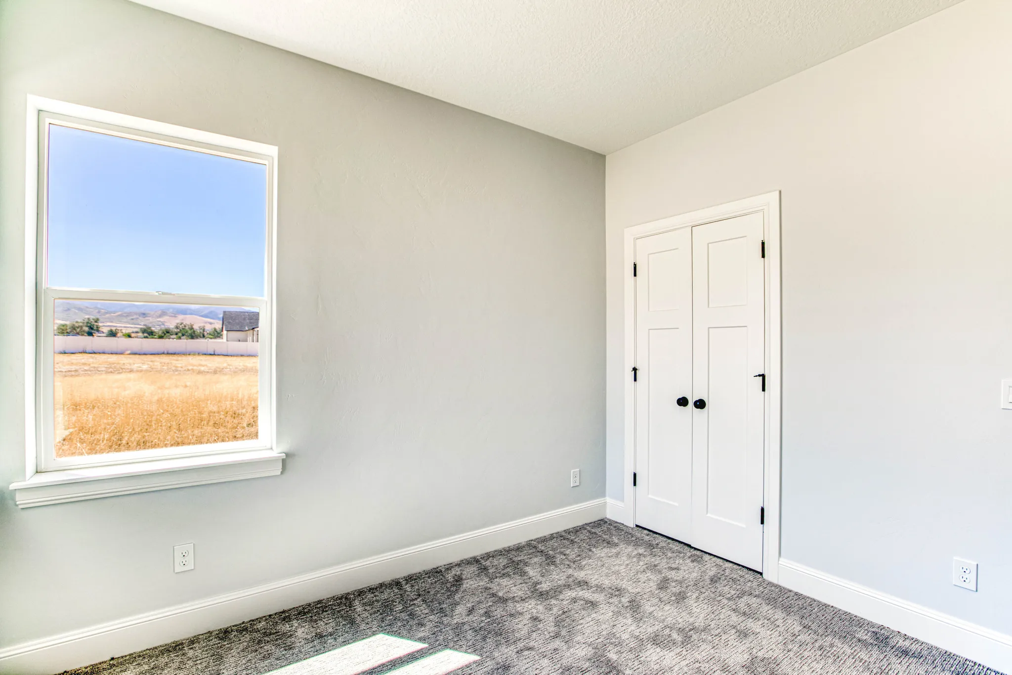 Neutral wall finishes, white trim, and a window providing natural illumination