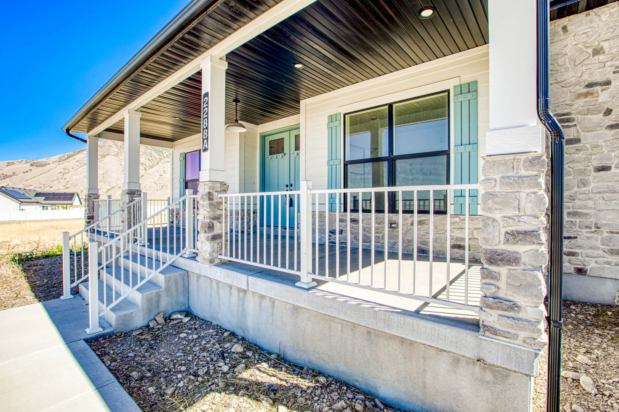 Covered front porch with stone-clad columns