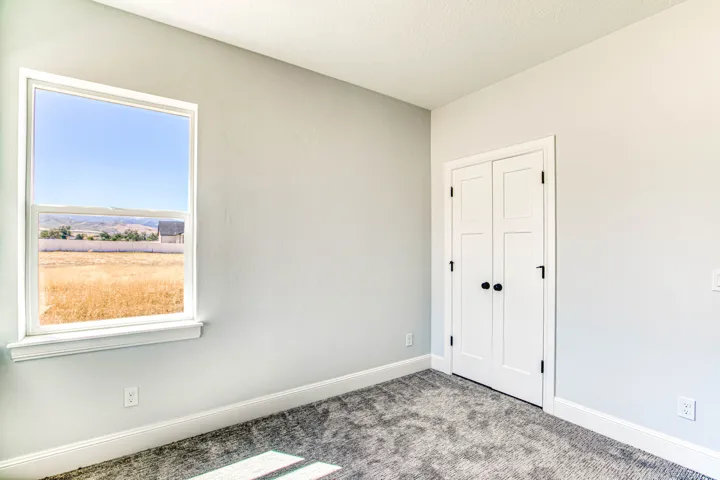 Neutral wall finishes, white trim, and a window providing natural illumination