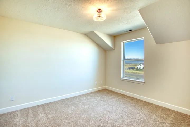 Recessed window with a white frame, neutral carpet flooring, and a semi-flush mount ceiling fixture