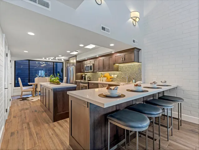 Kitchen with custom oak cabinetry and solid surface counters.