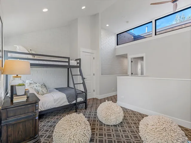 Loft with bunk beds and high windows