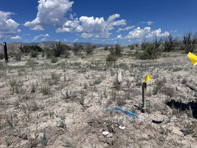 Expansive lot featuring rugged terrain and distant mountain range