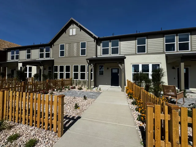 Modern townhouse facade with horizontal siding and accent shutters