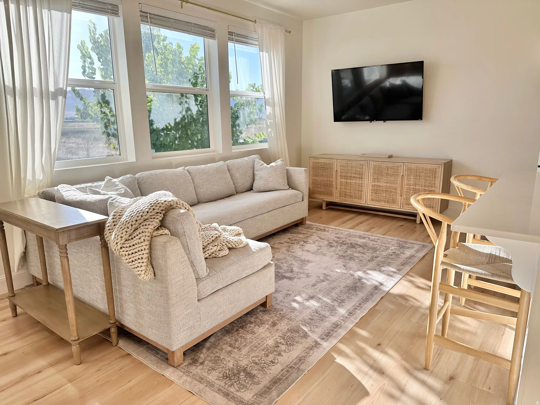 Light wood-finish flooring complements the neutral wall tones