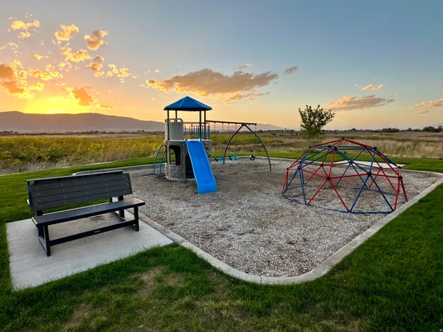 Community playground with a play structure, slide, swings, and climbing dome