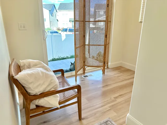 Wood-finish flooring with white wall trim