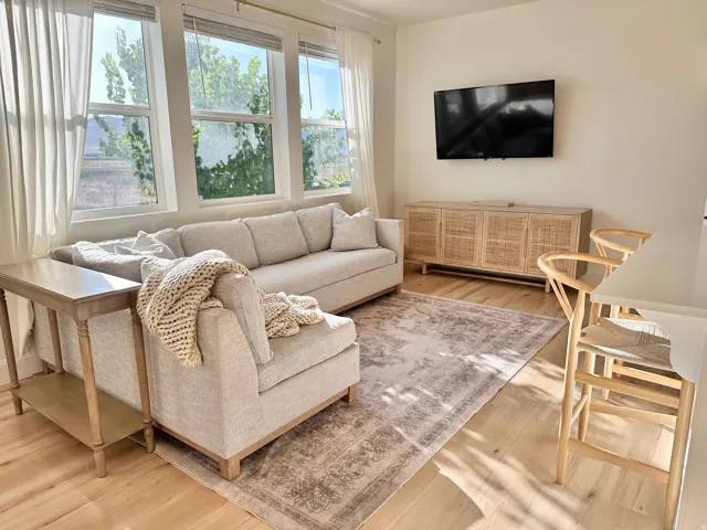 Light wood-finish flooring complements the neutral wall tones