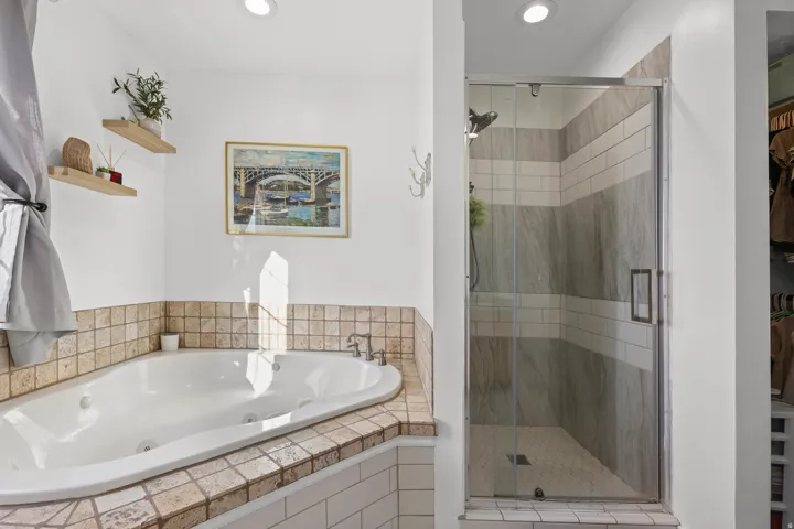 Great soaking tub and separate shower in the primary bathroom