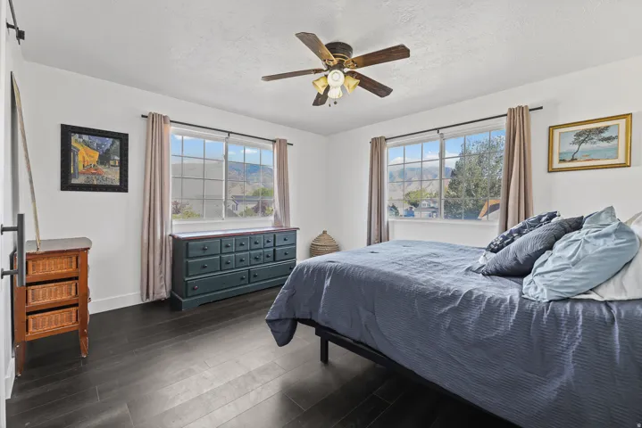 Large primary bedroom with views of the mountains and the lake