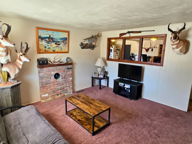 Brick fireplace with a wood mantel