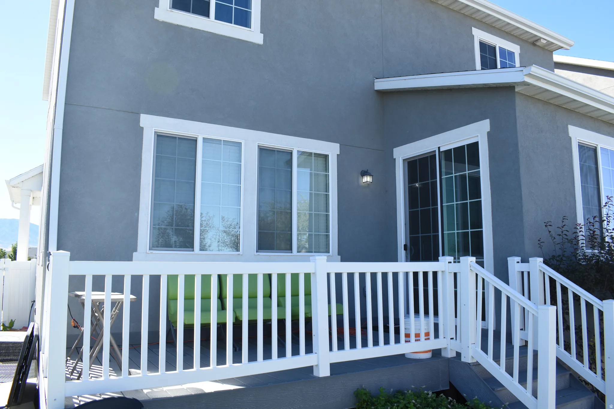 Exterior featuring stucco siding, white-framed windows, and white-framed sliding glass doors