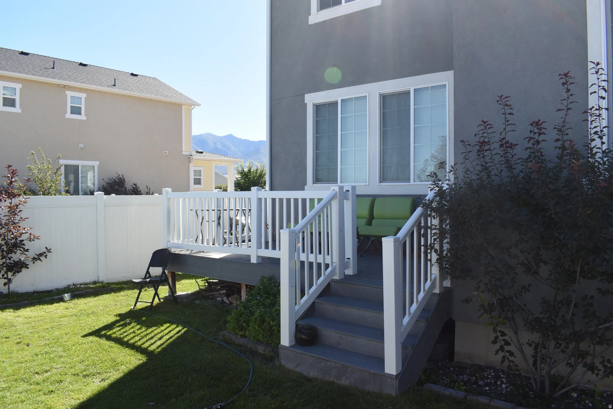 Rear deck with white railing and steps