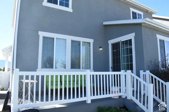 Exterior featuring stucco siding, white-framed windows, and white-framed sliding glass doors