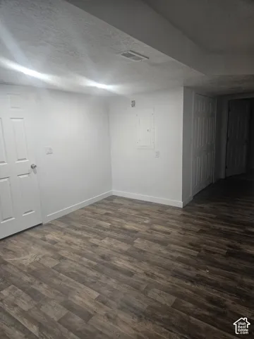 Wood-finish flooring with white trim and paneled doors