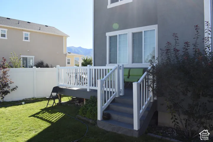 Rear deck with white railing and steps
