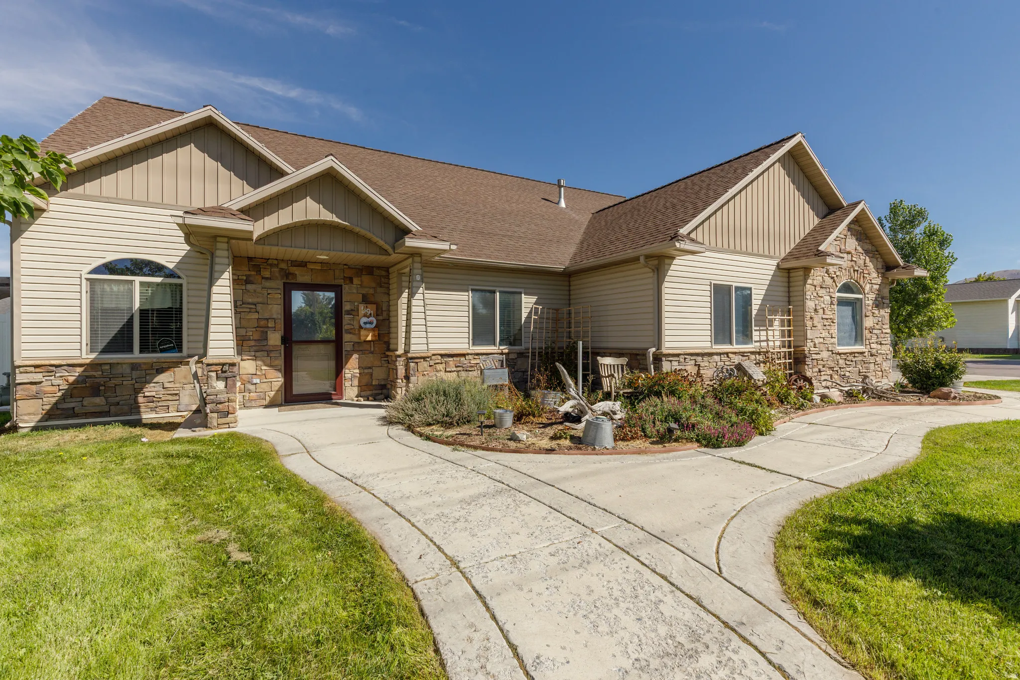 Exterior featuring stone accents, horizontal siding, and multiple gables