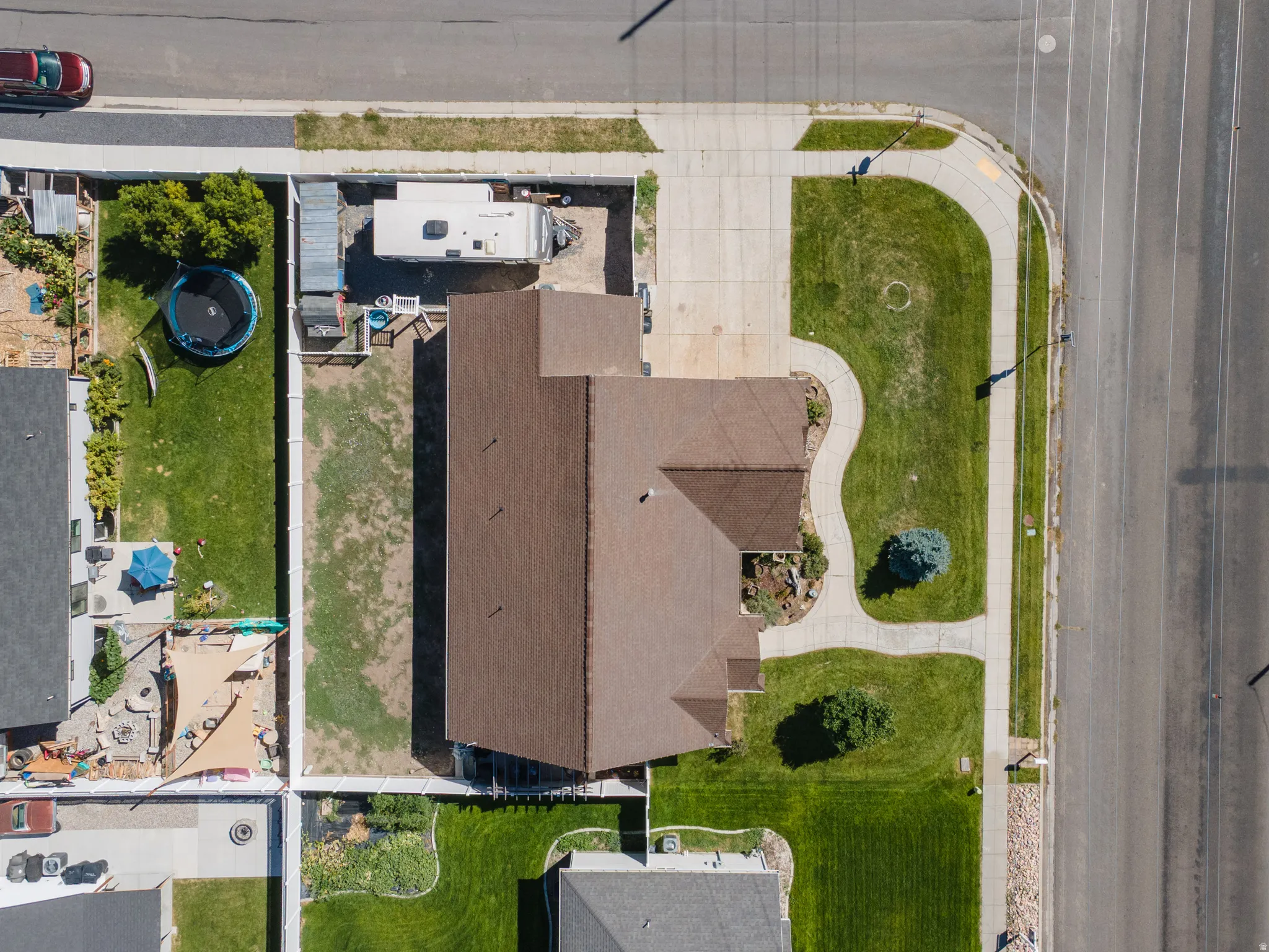 Expansive corner lot featuring a well-maintained lawn and mature landscaping