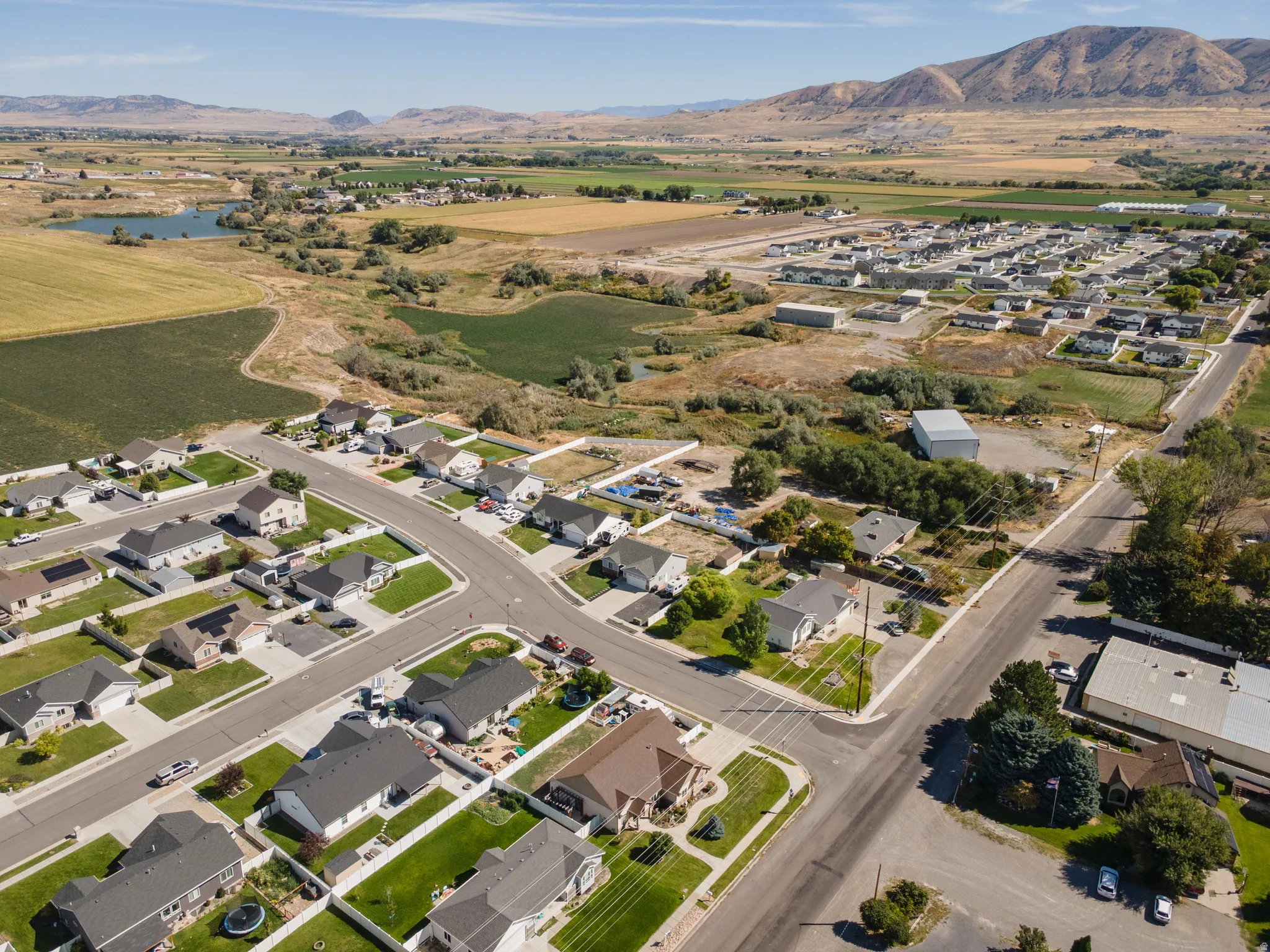 Residential area featuring established homes, paved streets, and mountainous terrain