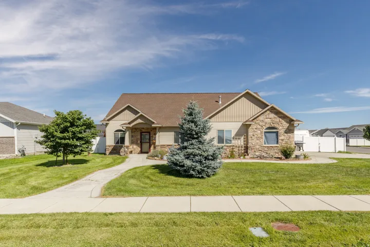 Exterior featuring stone and siding finishes, a brown shingle roof, a concrete walkway, and a concrete driveway