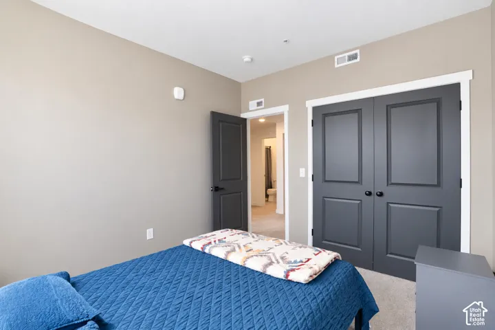 Bedroom 1 Neutral tone walls complement the dark panel doors with black hardware