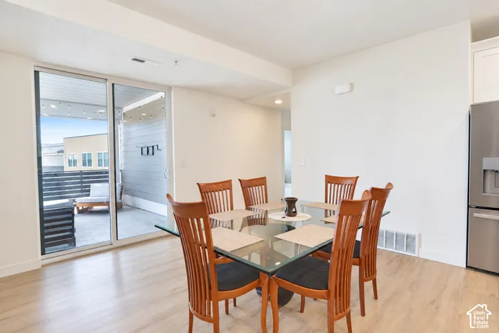 Spacious dining area with sliding door that opens to large balcony