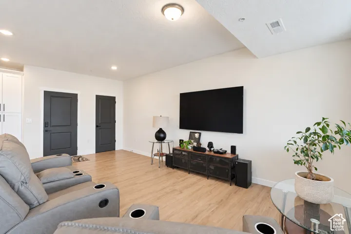 Light wood-finish flooring with recessed ceiling lighting