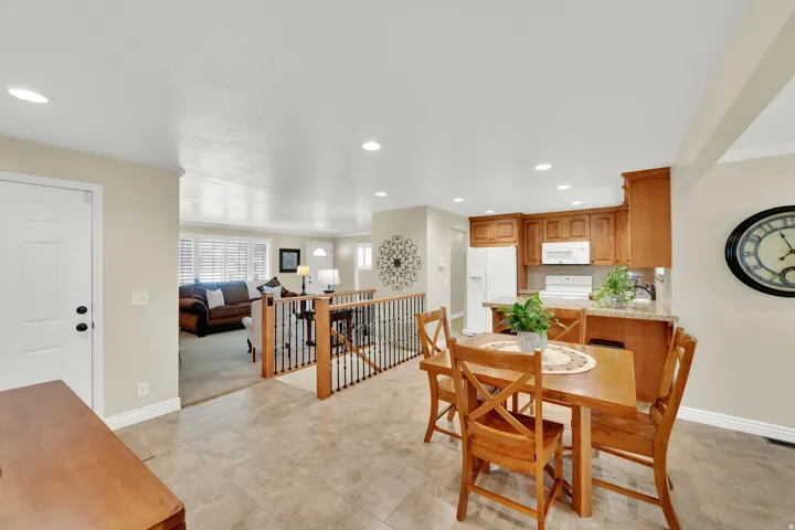 Recessed lighting, tile flooring, wood cabinetry, stone-finish countertops, and an open-concept layout