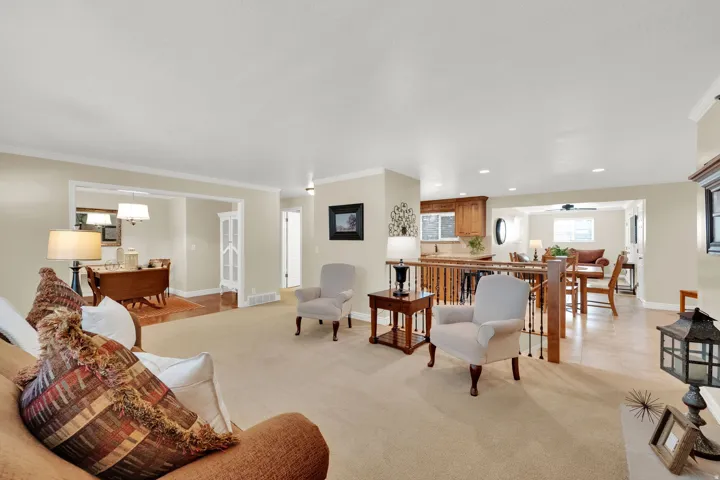 Spacious living area with carpet flooring, recessed lighting, and crown molding